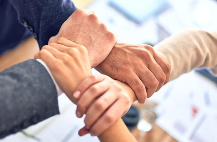 Photo by krakenimages person in black long sleeve shirt holding persons hand